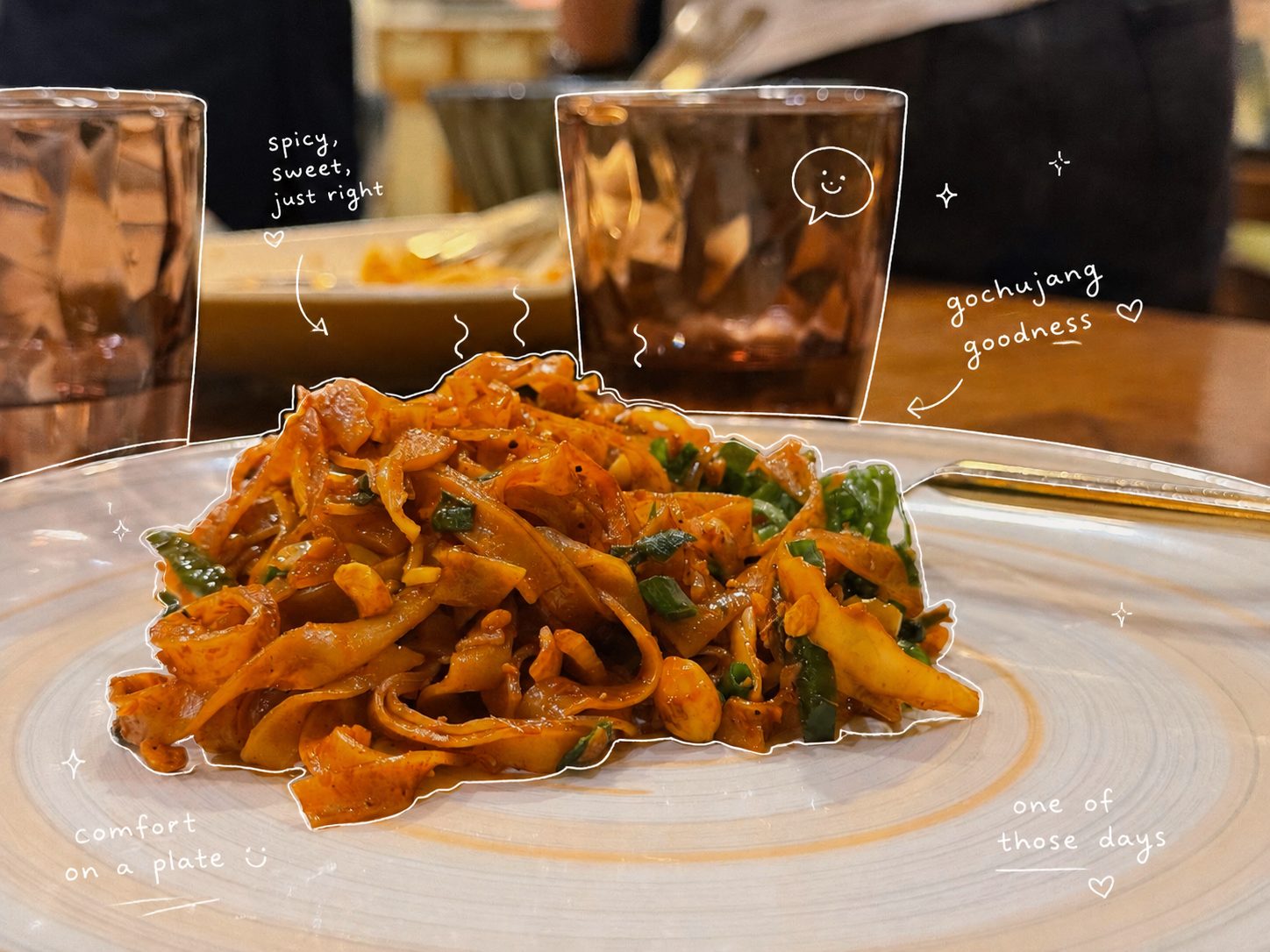 Wide rice noodles in glossy gochujang sauce with doodle notes