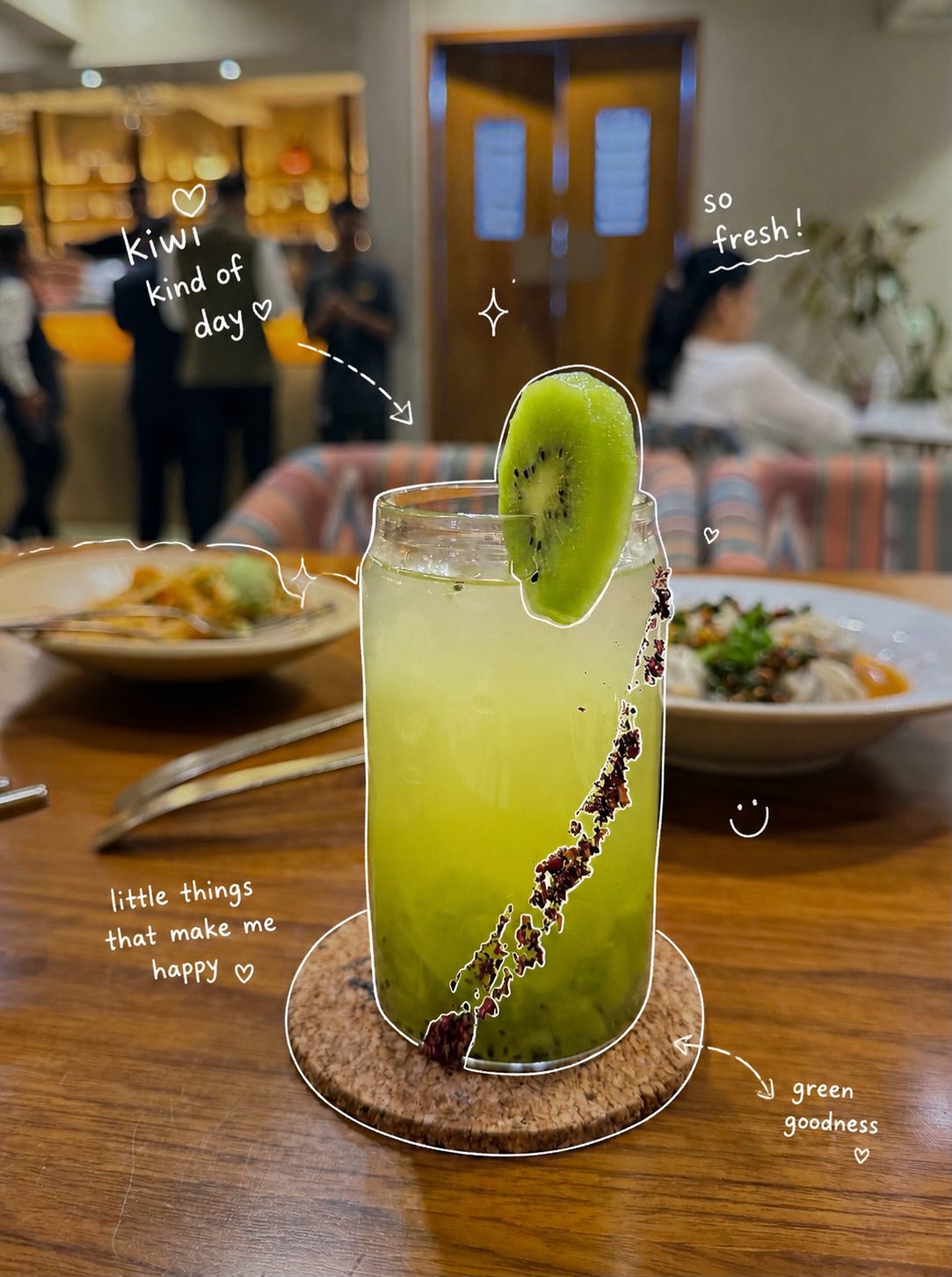 Bright green kiwi drink in a can-shaped glass with doodles