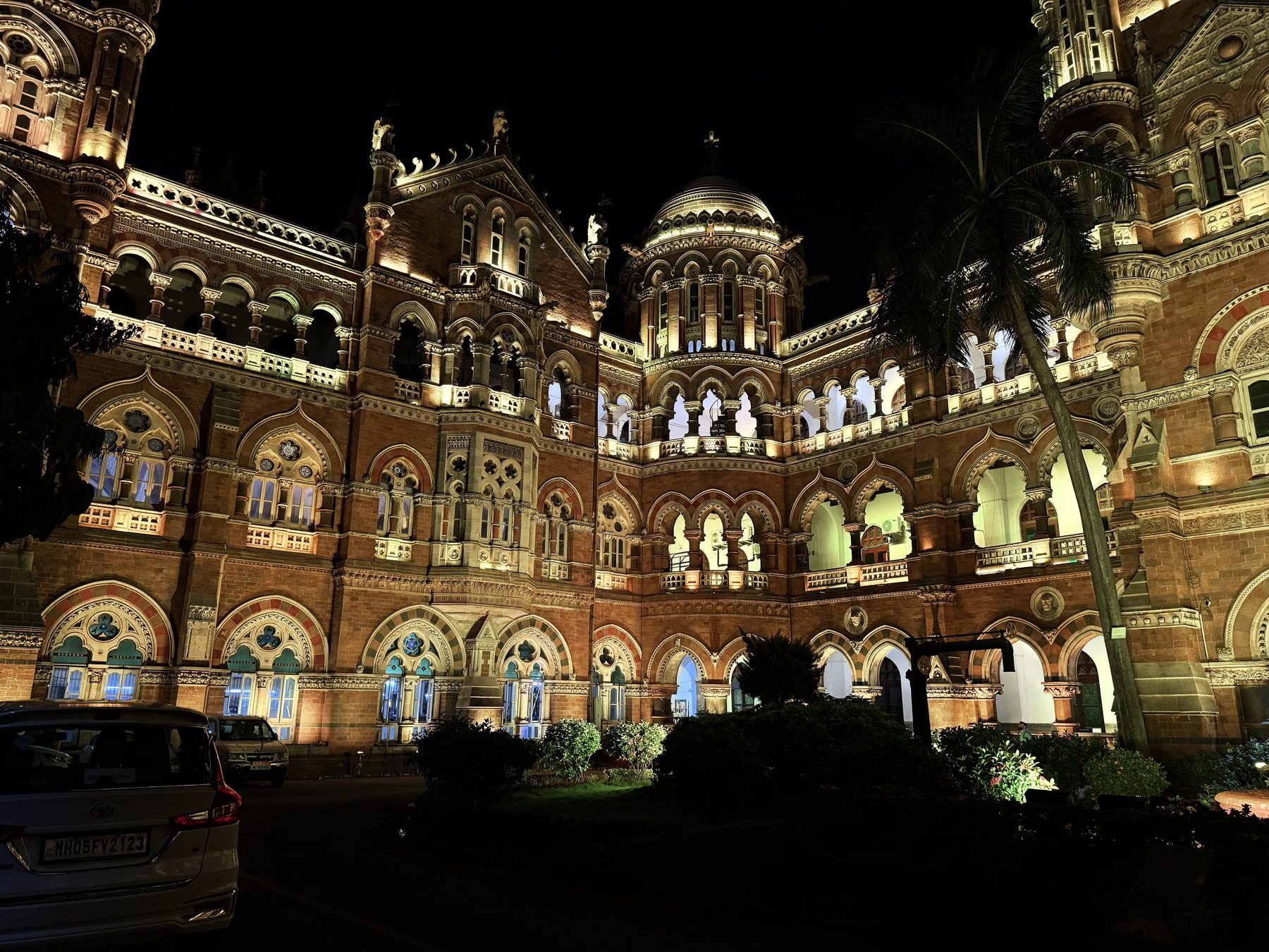 CSMT glowing in warm floodlights against a black night sky