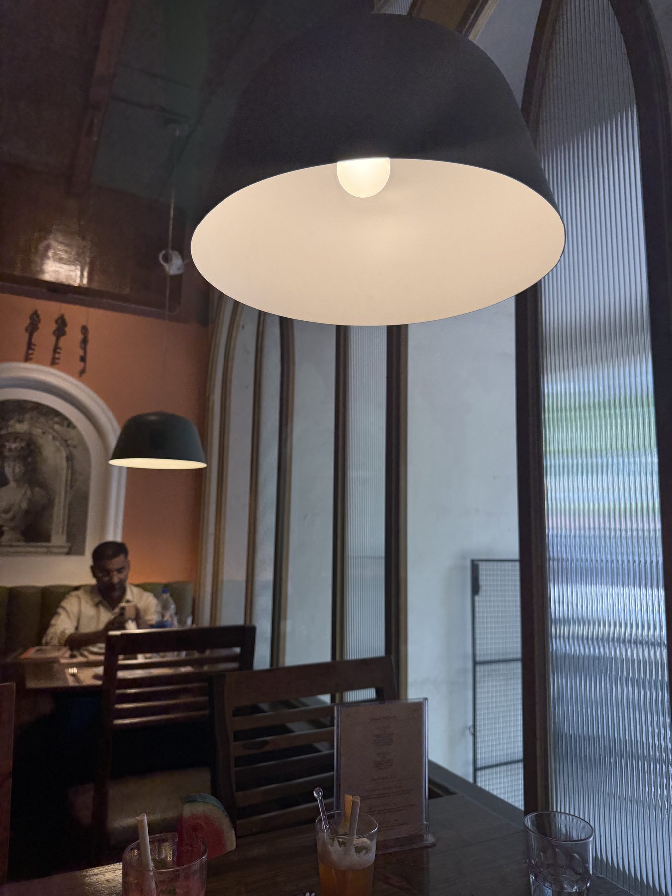 Moody restaurant interior with pendant lamps and colorful drinks